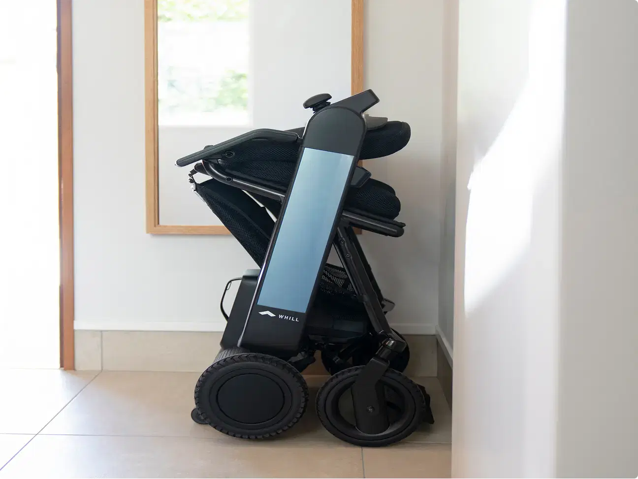 WHILL Model F electric wheelchair in compact folded position